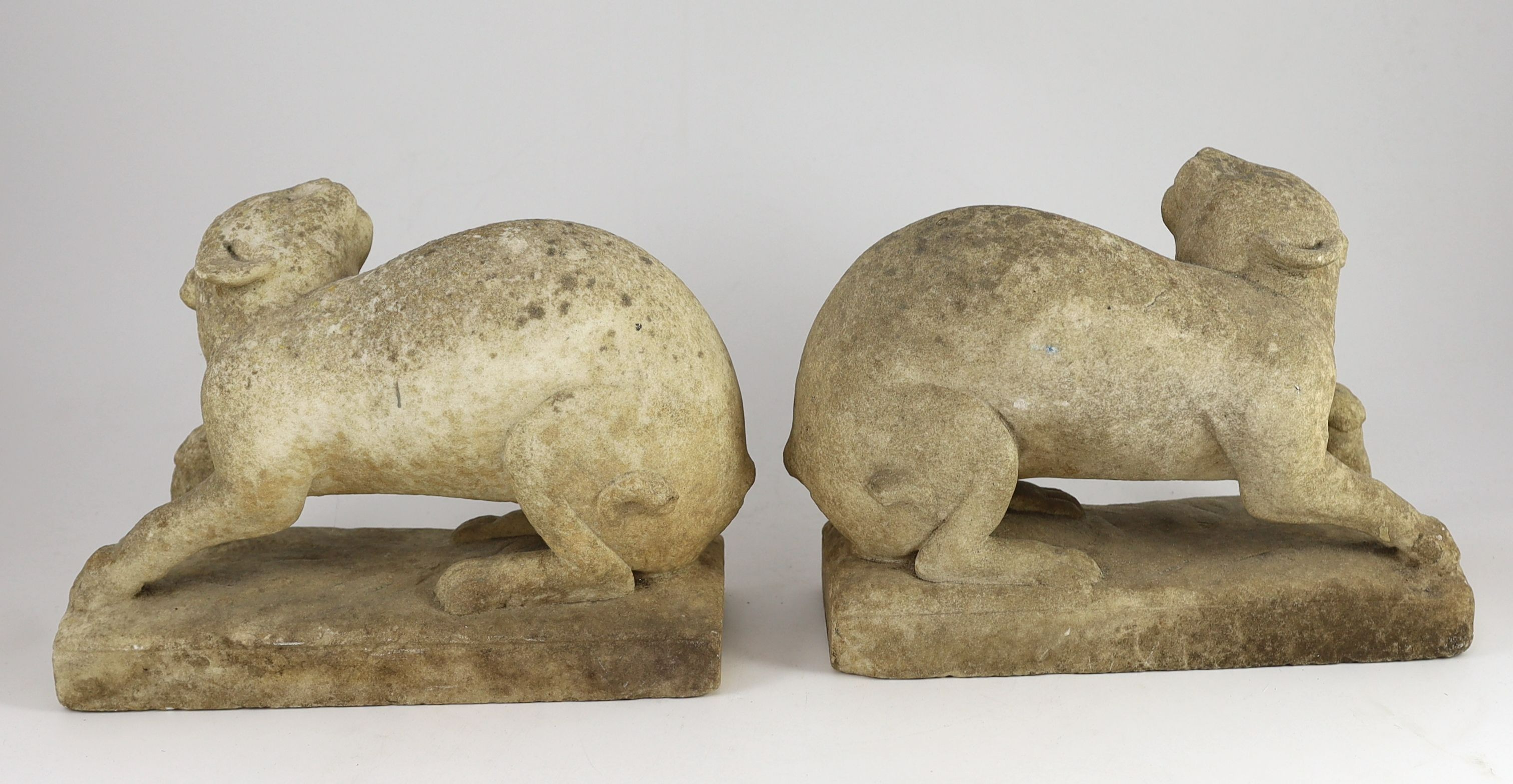 A pair of 19th century carved marble models of crouching cats, width 32cm, depth 12cm, height 22cm